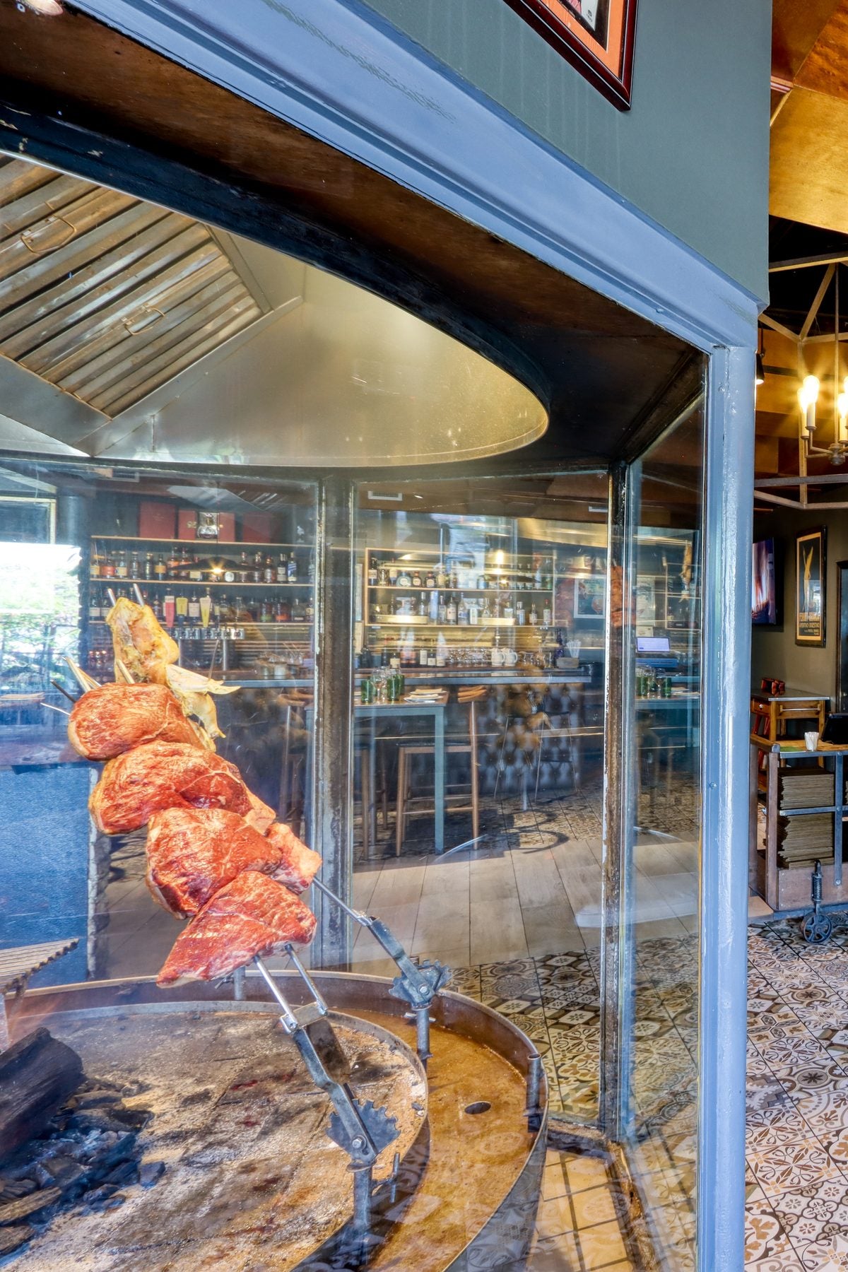 Skewers roasting in the asador display at Graziano's Bird Road