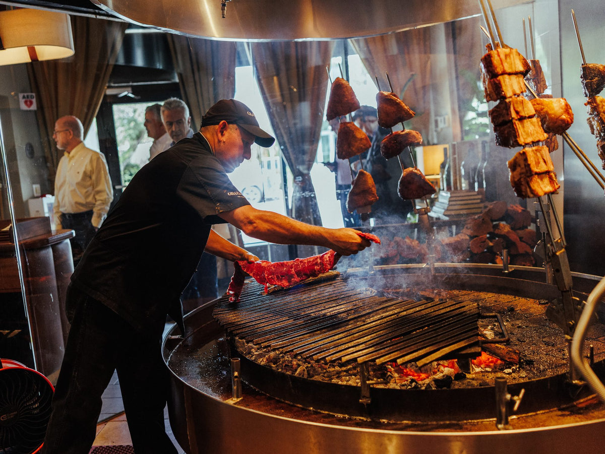 Turning skewers over the open fire grill at Graziano's