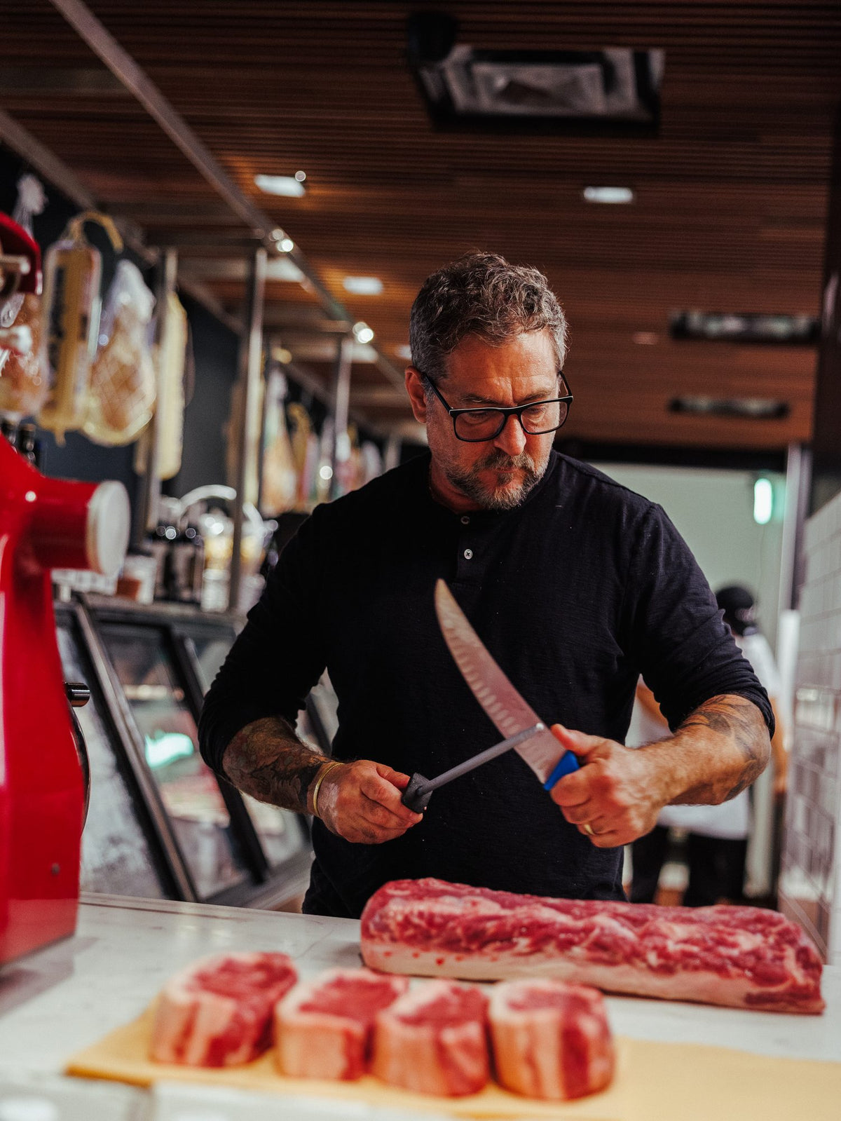 Slicing steaks at the butcher counter at Graziano's Mercado