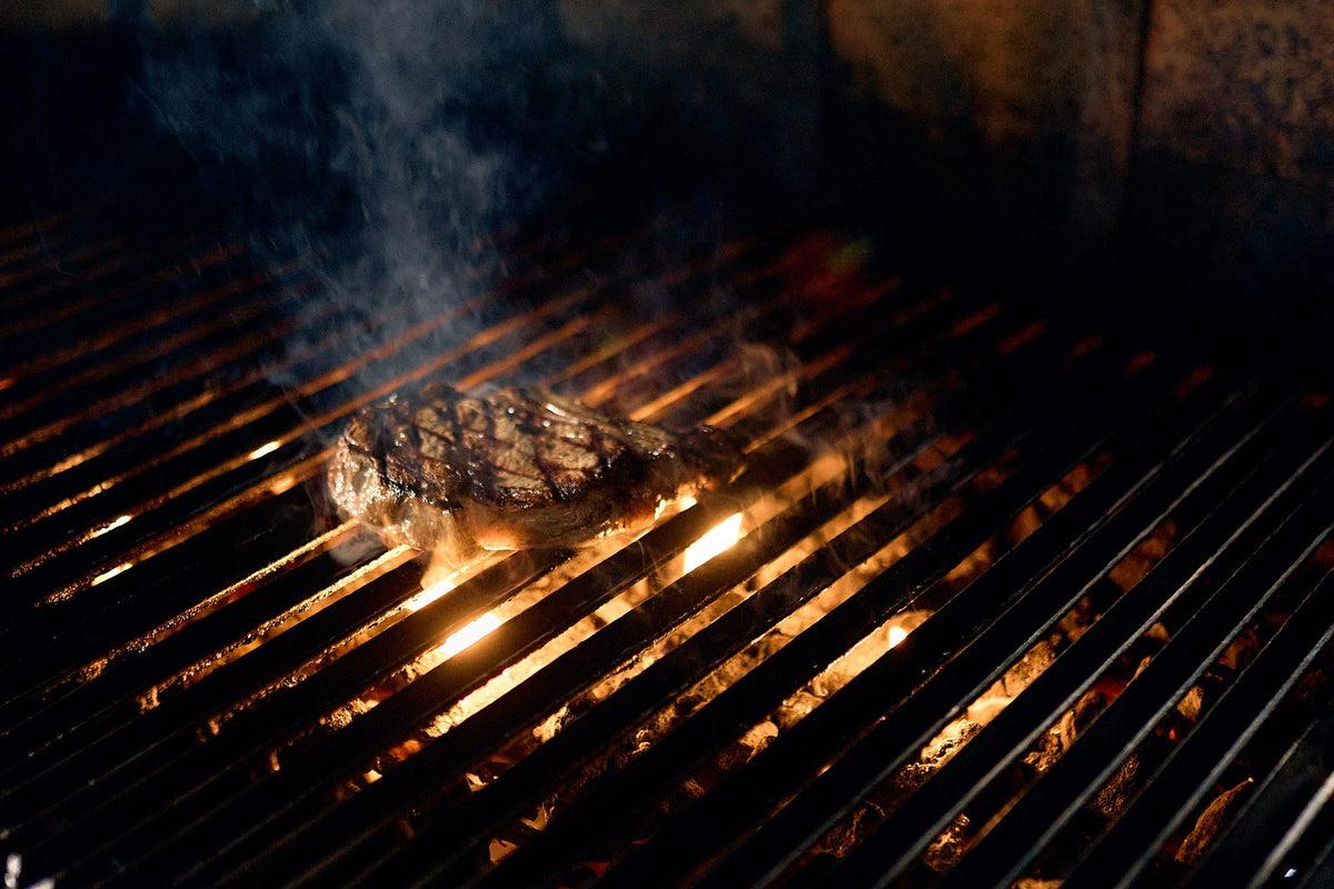 Steak on the parrilla over the flames at Graziano's