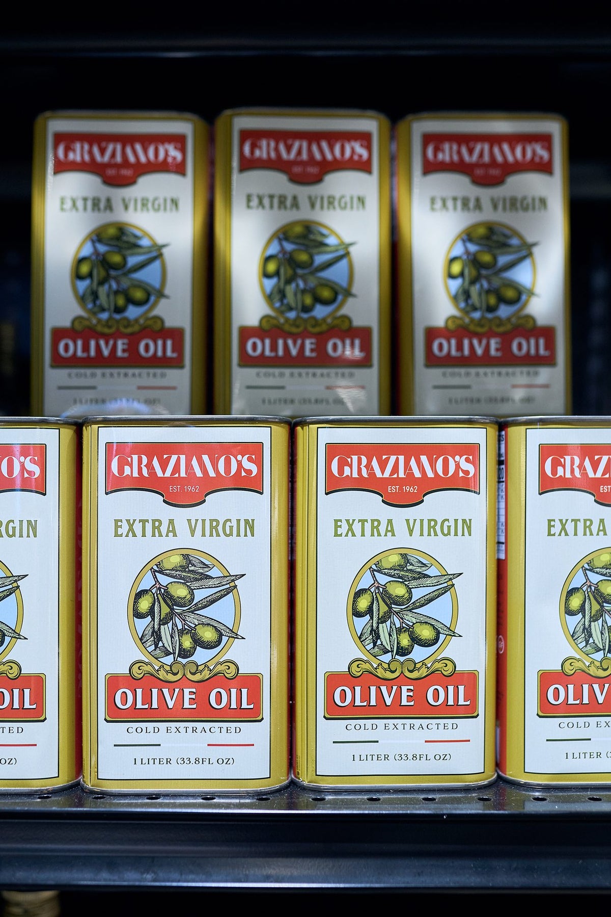 Graziano's extra virgin olive oil tins on the mercado shelf