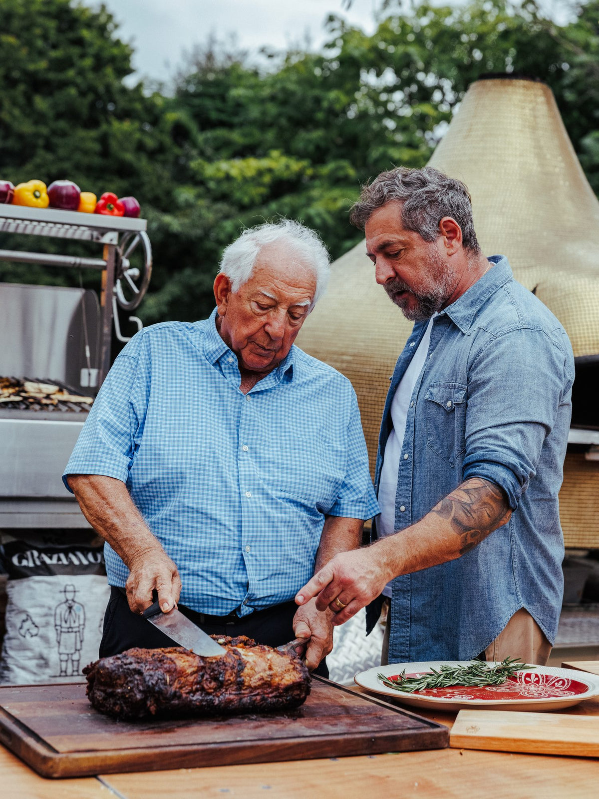Carving a tomahawk at an outdoor asado