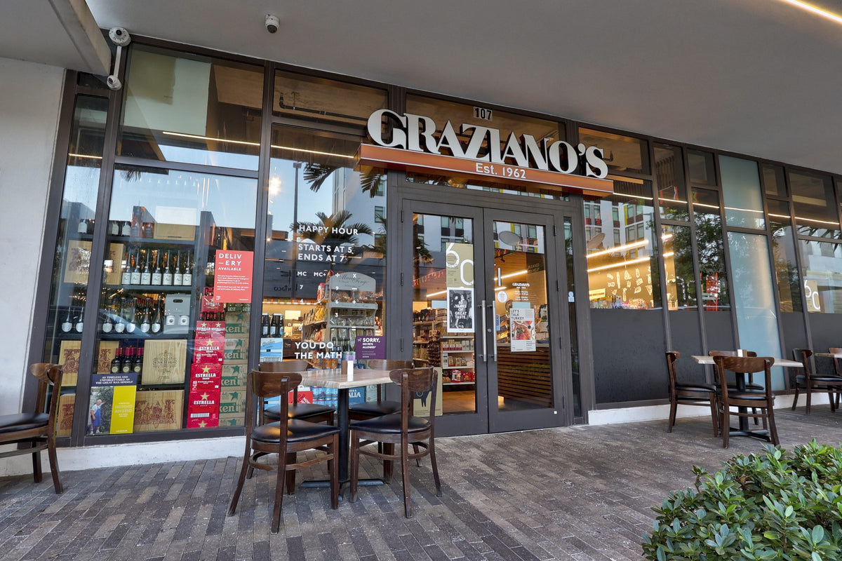 Graziano's Mercado Aventura storefront with outdoor tables