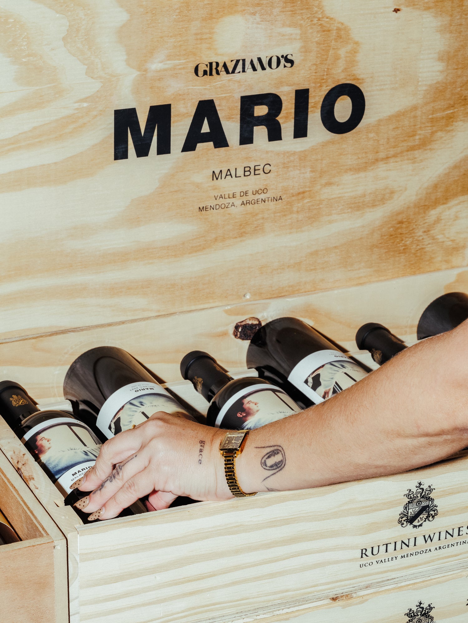 Wooden wine box with bottles of Graziano's Mario Malbec wine.